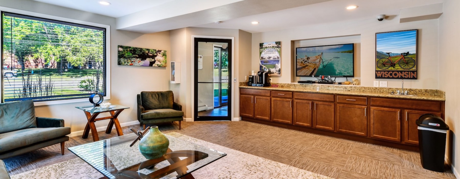 a clubroom with chairs, a coffee table and a tv