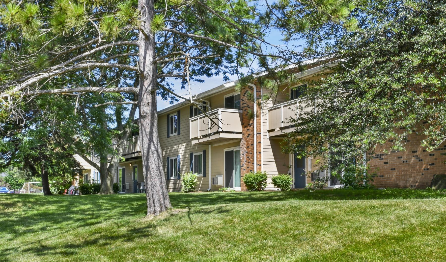 a building with a lawn and trees