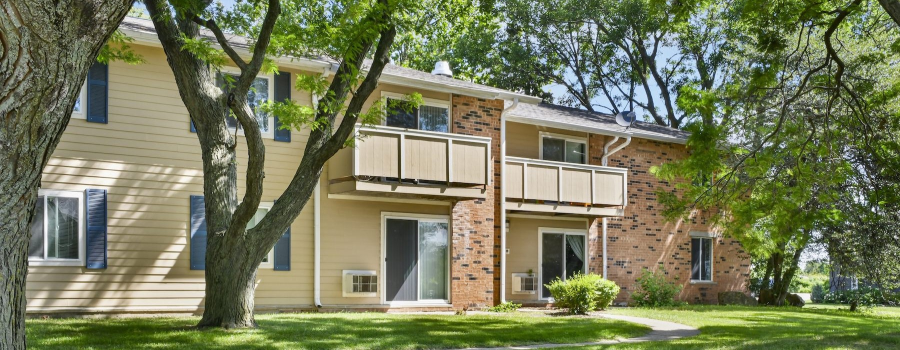 a building with a lawn and trees