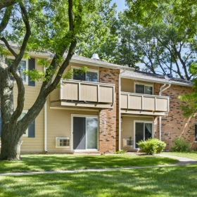 a building with a lawn and trees