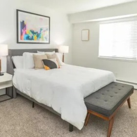 a bedroom with a bed and a bench