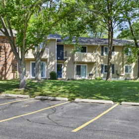 a large house with trees and grass